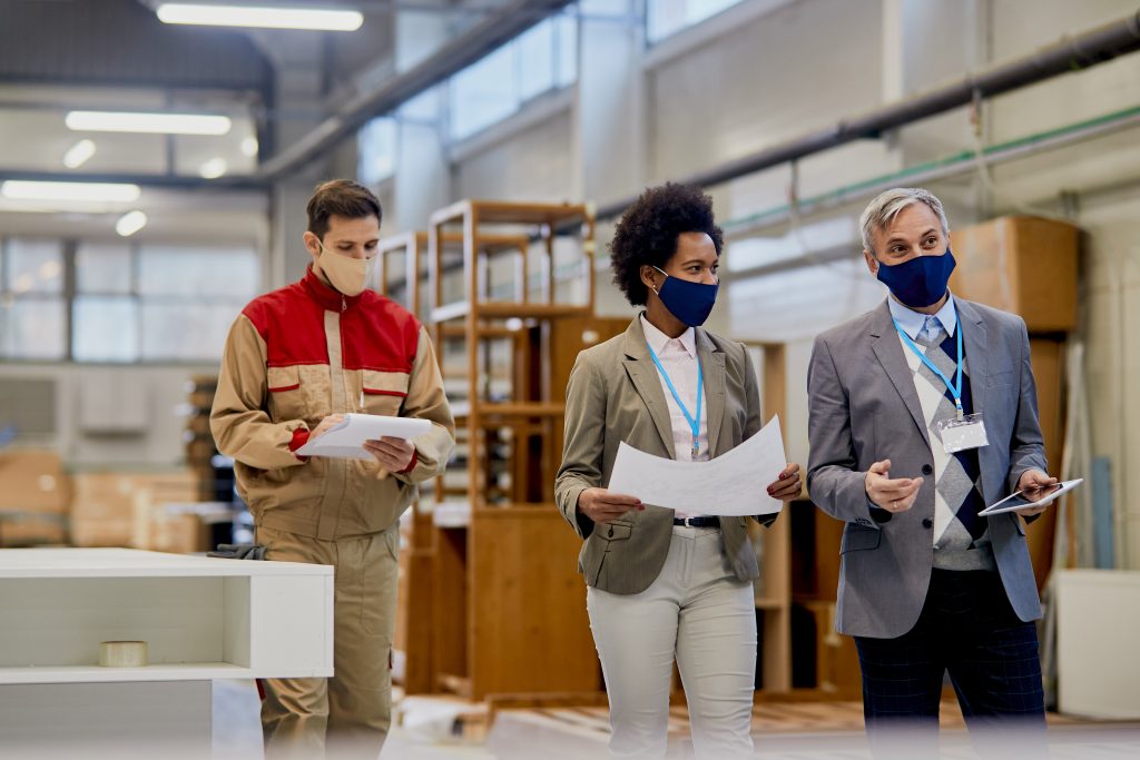 Quality control inspectors communicating while walking through w